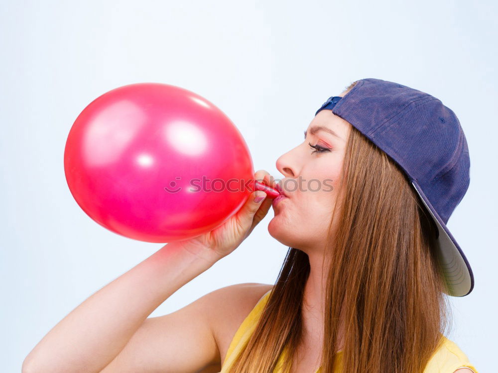 Similar – Thoughtful, dreamy, sweet girl with a white balloon in her hand in the garden, looks into the camera. Dear birthday girl outside in the nature is happy about a gift balloon for her party, holds it tight and puts it in her mouth.