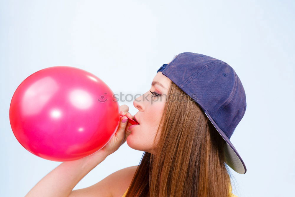 Similar – Thoughtful, dreamy, sweet girl with a white balloon in her hand in the garden, looks into the camera. Dear birthday girl outside in the nature is happy about a gift balloon for her party, holds it tight and puts it in her mouth.