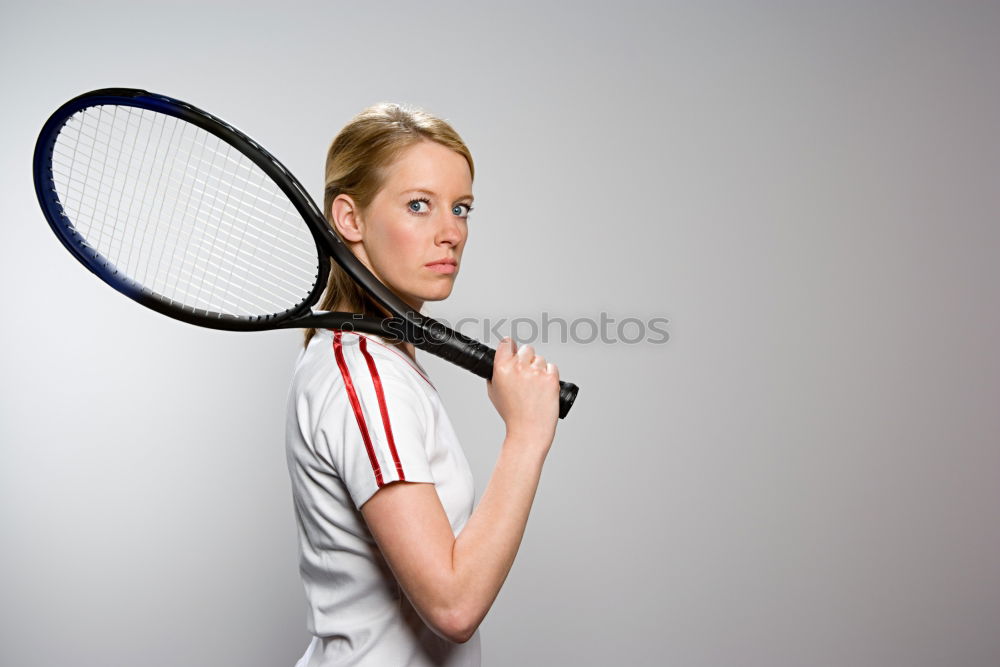 Similar – Face of a young woman hiding behind a featherball bat. Repeating the colour red. Sports grouch. Unsportsmanlike. Defense