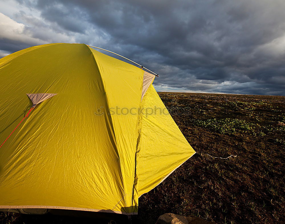 Tent in storm and rain in an autumn landscape