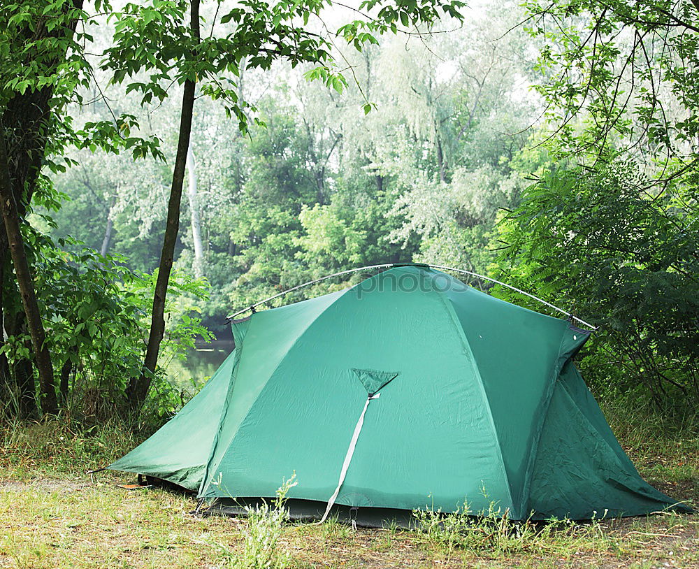 Similar – Orange tent in a pine forest