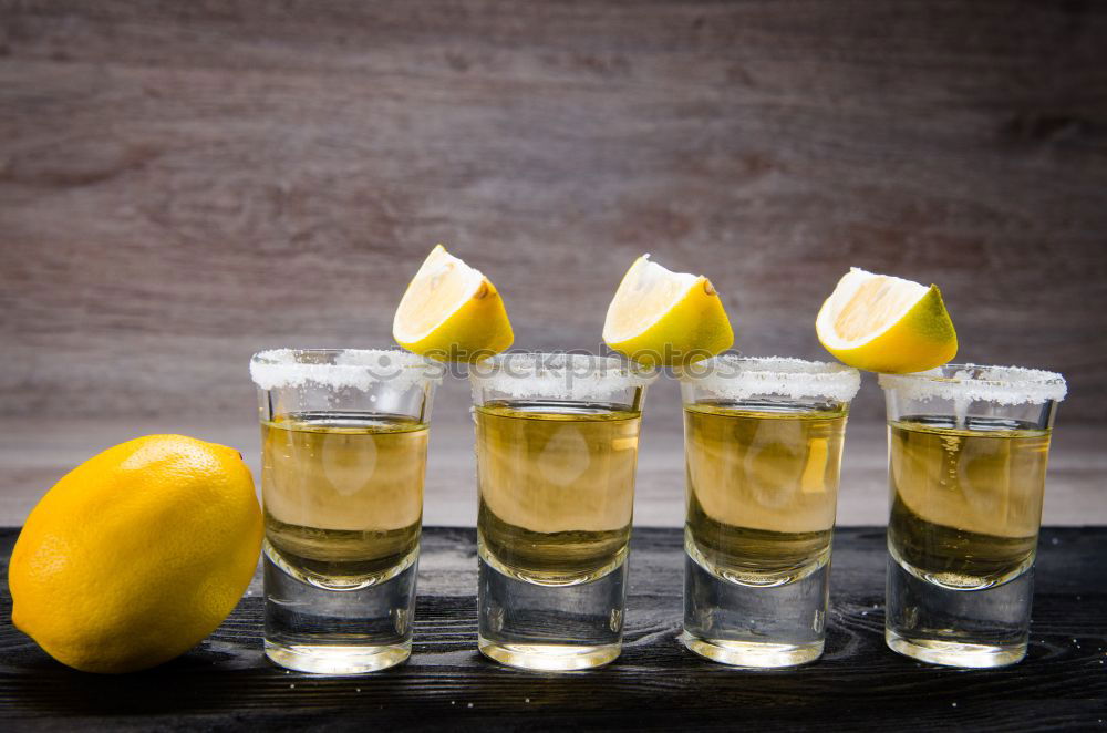 Tequila in shots with salt rim and lemon