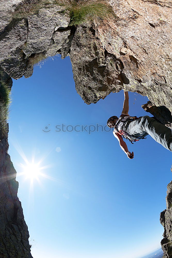 Similar – Image, Stock Photo Anonymous climber handing on cliff