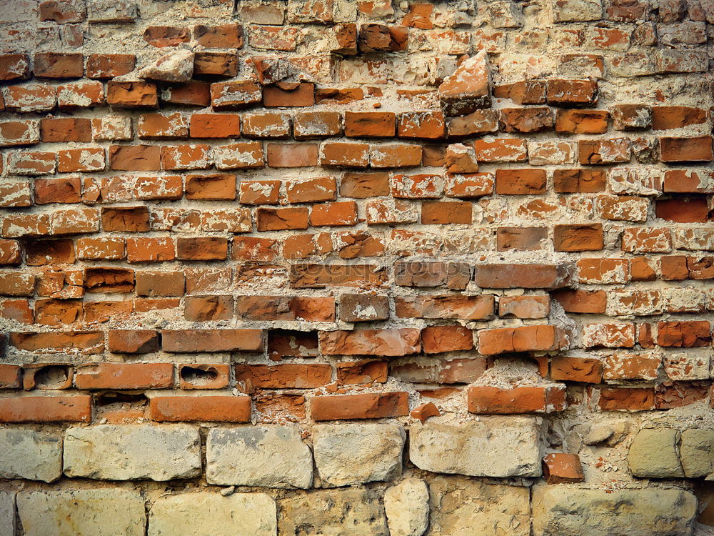 Similar – Abgefallener Putz an Backsteinwand. Verwitterte  Wand aus Backstein, Naturstein und marodem Putz. Sanierungsbedürftig