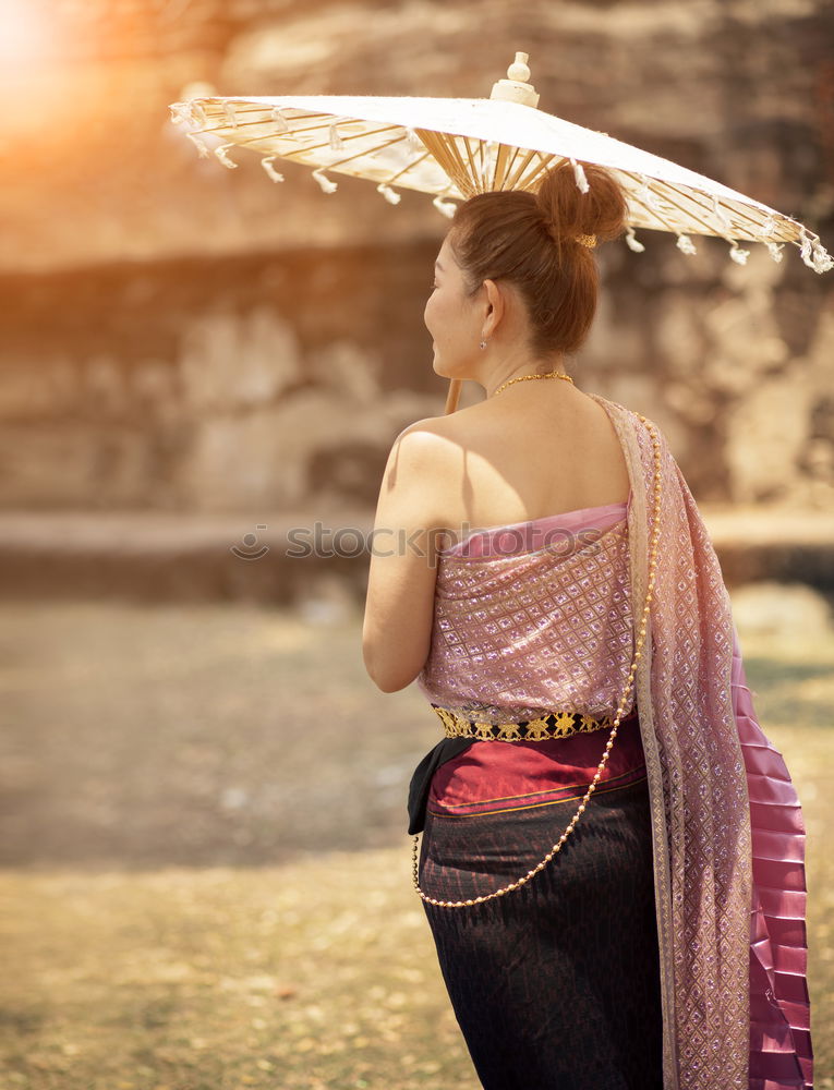 Similar – Pretty Asian woman sitting at pond