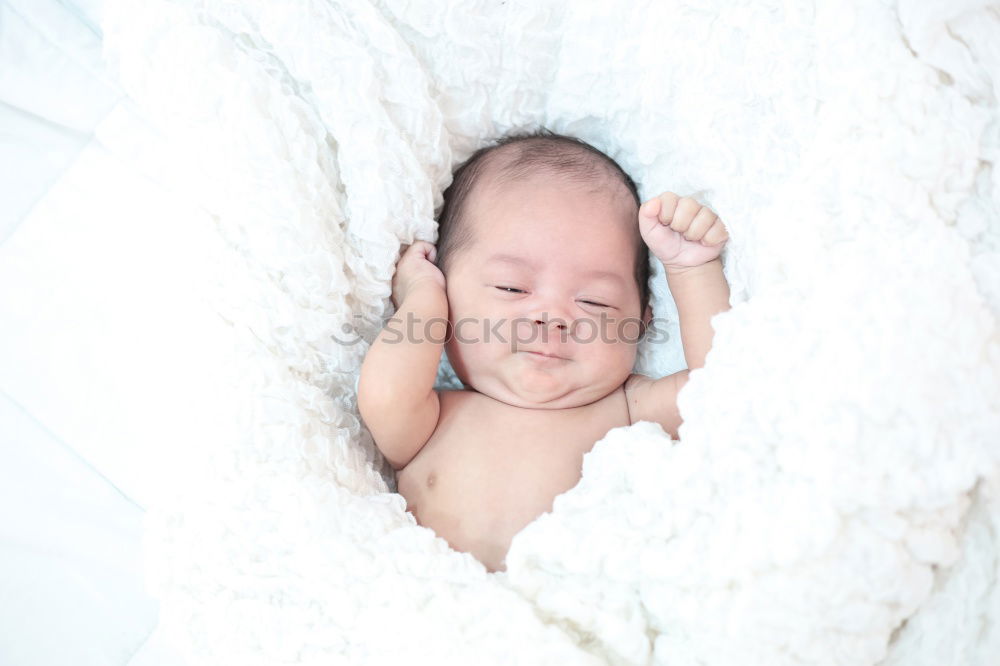 Similar – Baby sleeping on a blanket