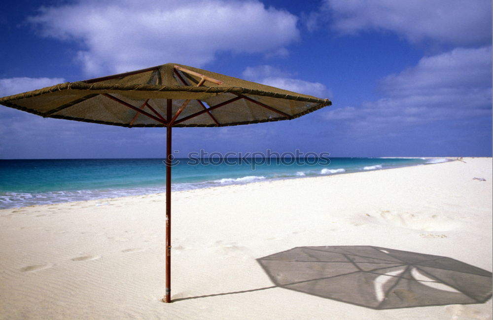 Similar – beach of sand with sun hat