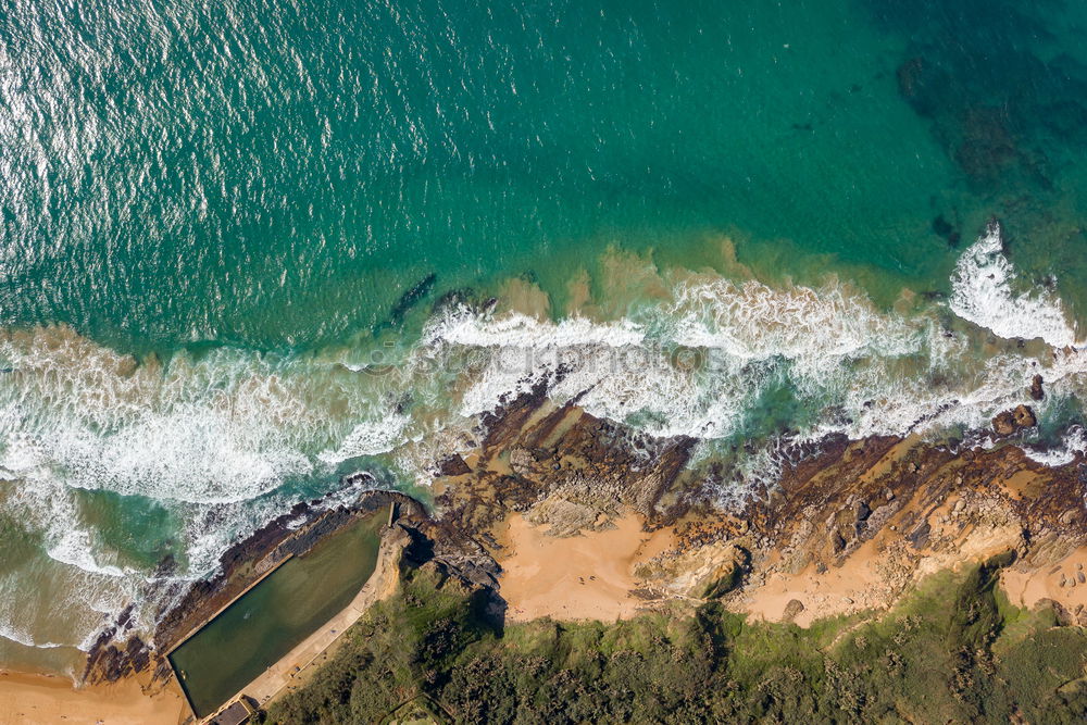 Similar – Rockpool surrounded by the ocean on a sunny day