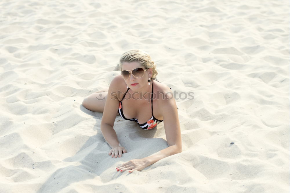 big woman sitting at the Baltic Sea beach