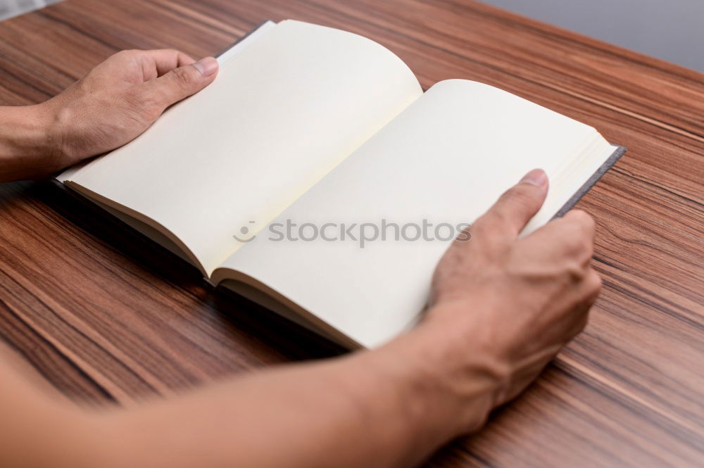 Similar – A woman’s hand holding an empty notebook