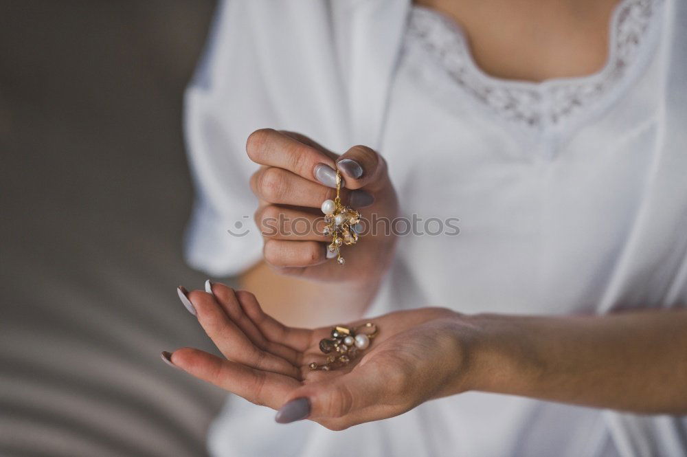 Elegante junge Frauenhände mit bemalten Nägeln und Schmuck