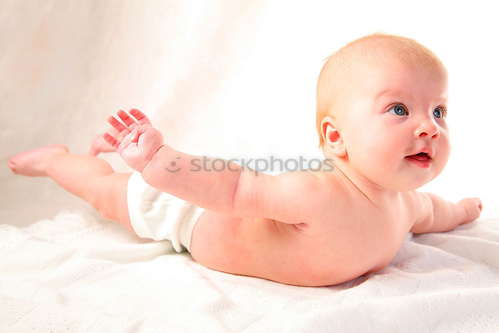 Similar – Happy baby girl, four months old, on the bed with pacifier.