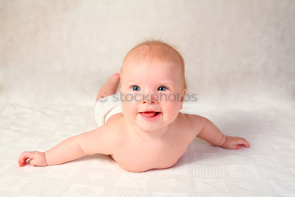 Similar – Happy baby girl, four months old, on the bed with pacifier.