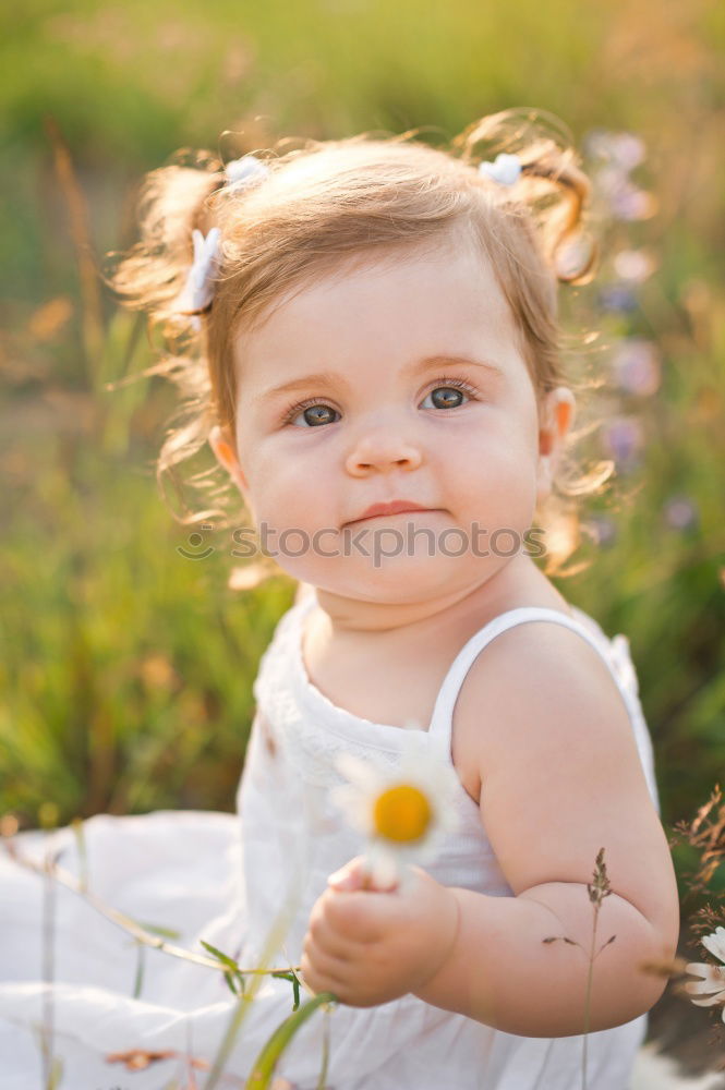 Similar – Little girl walking in nature field wearing beautiful dress