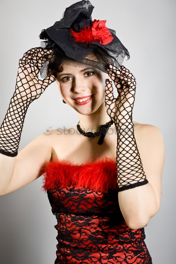 Similar – Young woman with black dress and red bow in her hair. Fashion photography. Autumn / winter fashion. Hair accessory.