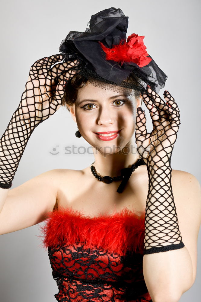 Young woman with black dress and red bow in her hair. Fashion photography. Autumn / winter fashion. Hair accessory.