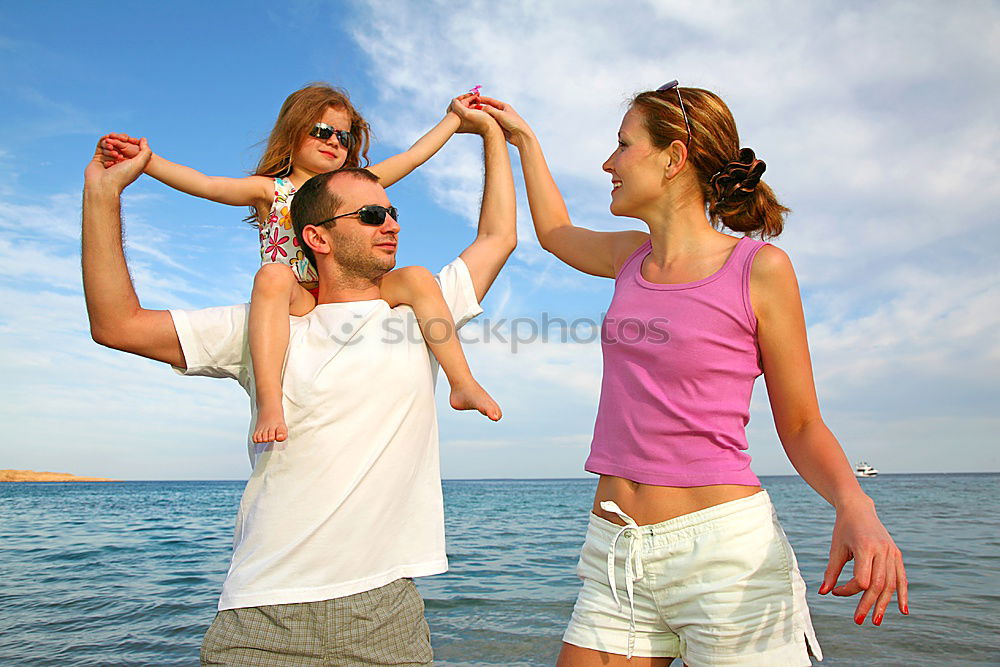Similar – Image, Stock Photo Happy family walking on the beach at the day time.