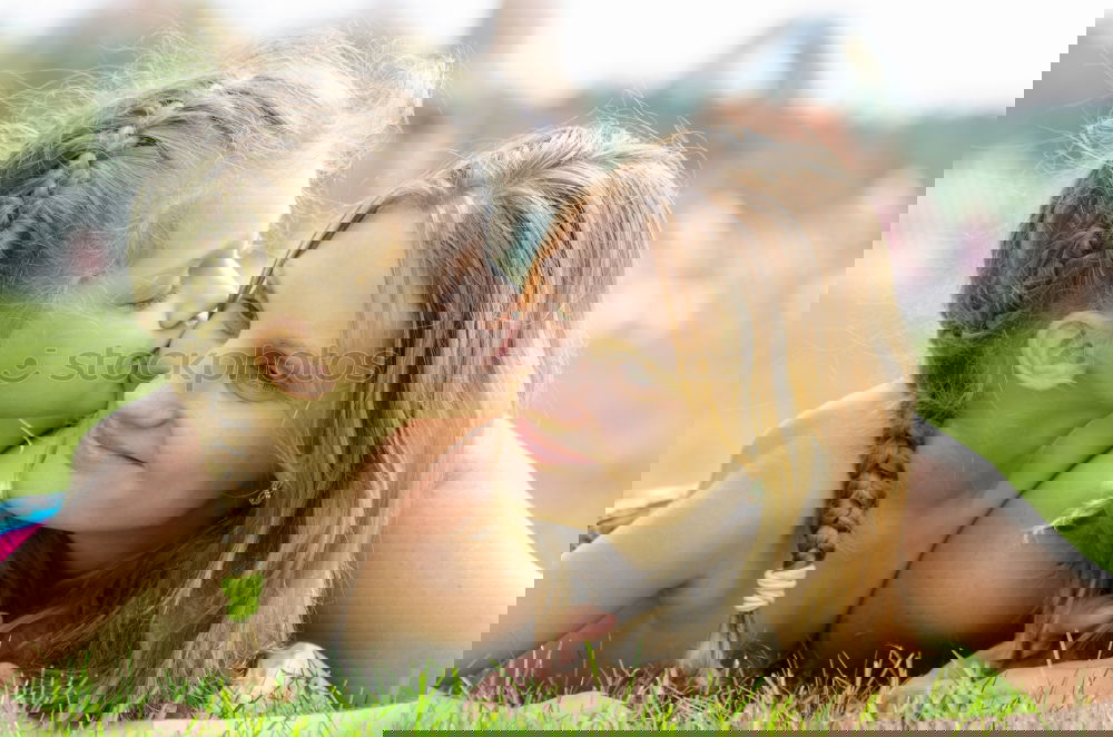 Similar – Image, Stock Photo Young mother forms heart with her children in the high grass