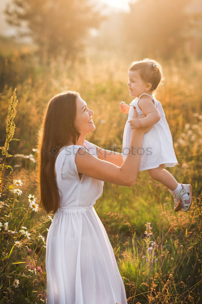 Similar – Image, Stock Photo Mother holding kid on hands in park