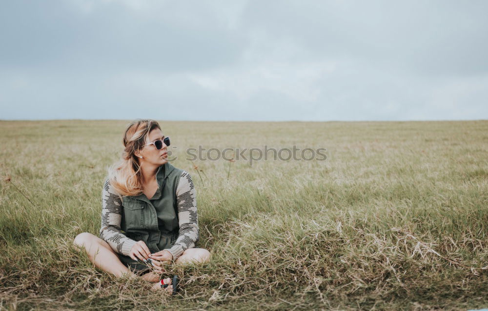 Similar – Image, Stock Photo Young woman with glasses and red rain jacket at the sea