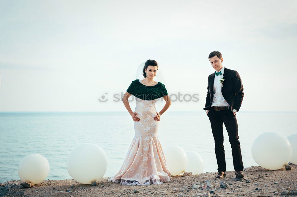 Similar – Bridal couple posing on sunny beach