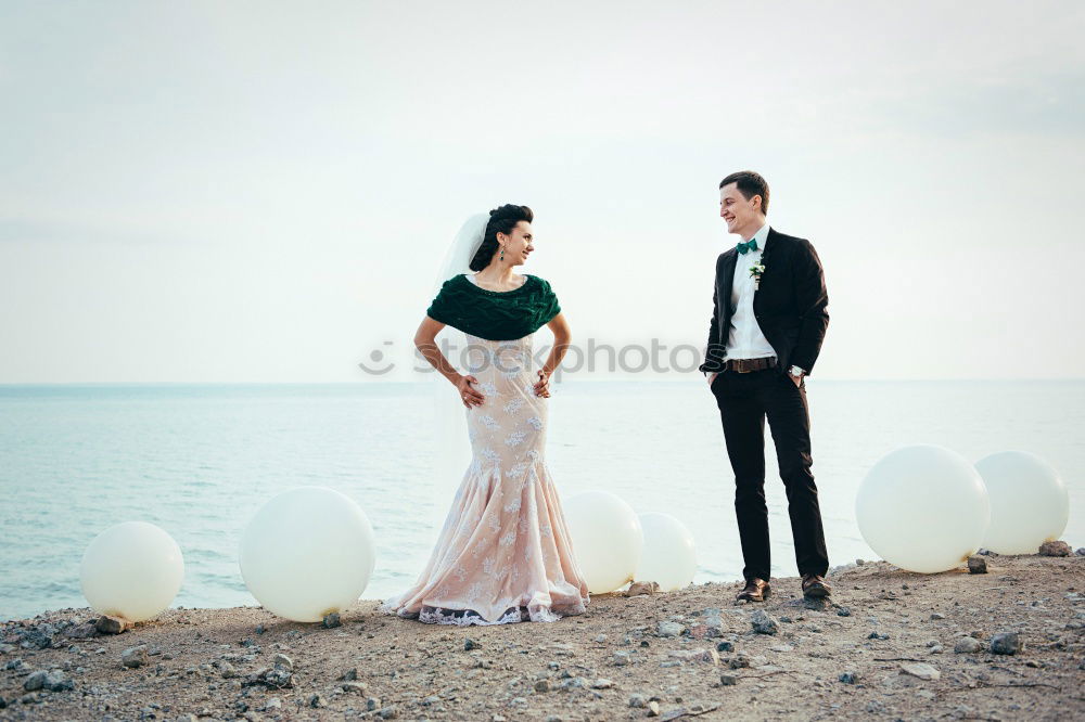 Similar – Bridal couple posing on sunny beach