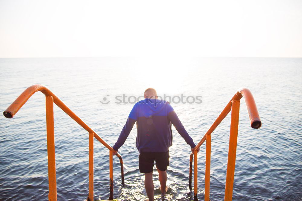 Similar – Person with surfboard standing near sea