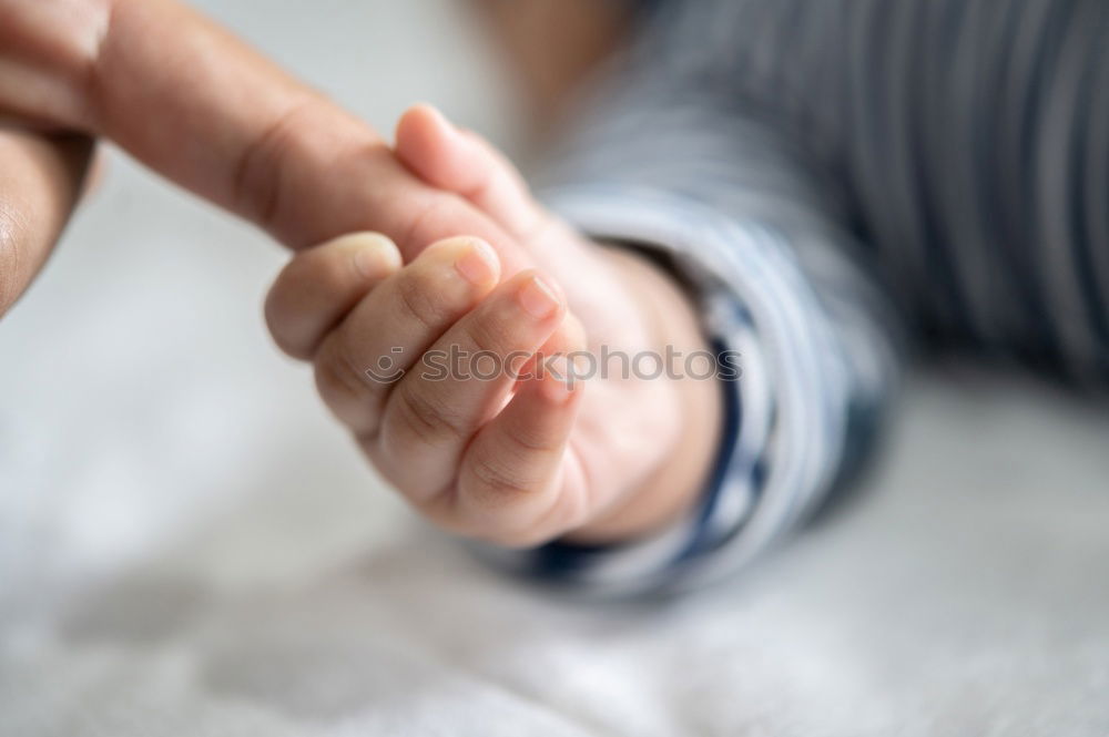 Similar – Baby girl sitting over legs of senior man outdoors