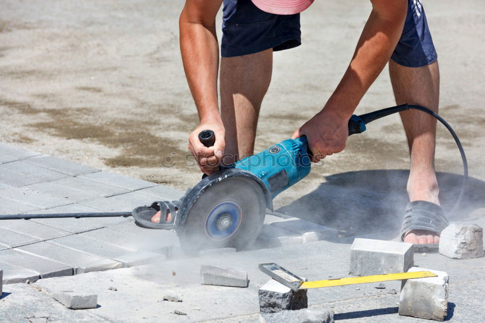 Flat roof installation with roofing felt, propane gas burner gas bottle. Construction work with roofing felt. Heating and melting of bitumen tar paper. Roof sealing