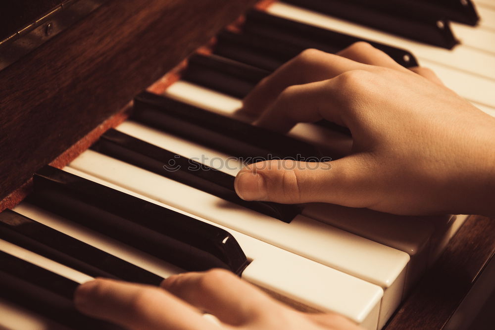 Similar – Toddler plays piano with delicate hands