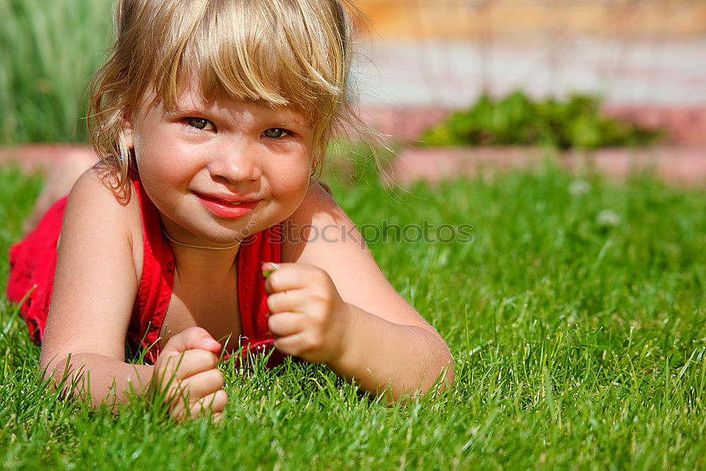 Similar – Funny, funny, cheerful, happy, funny blonde girl outside in the garden, looks up and sticks out her red tongue. Little joker is fooling around, fun with twisted eyes in nature, in the park with flowers and trees.