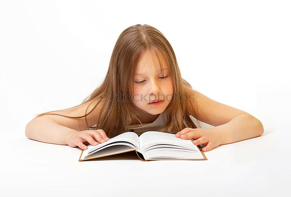 Similar – Schoolgirl reading a book in classroom