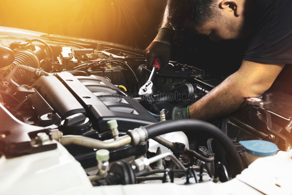 Similar – Professional Mechanic Repairing Car.