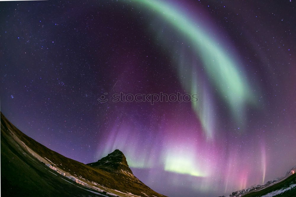 Similar – Northern lights before mountain silhouette