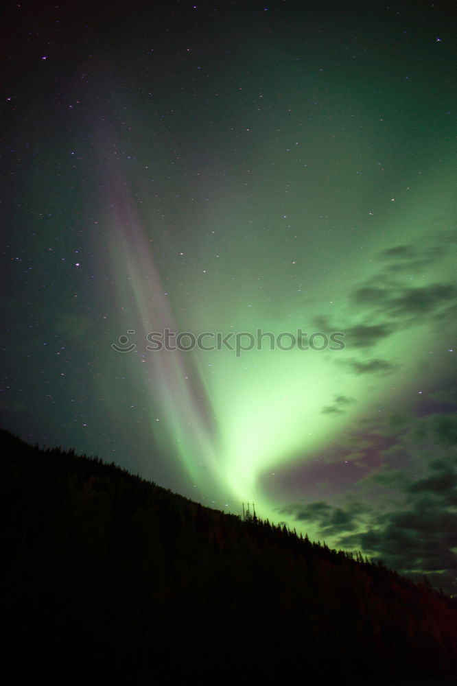 Similar – Northern lights before mountain silhouette