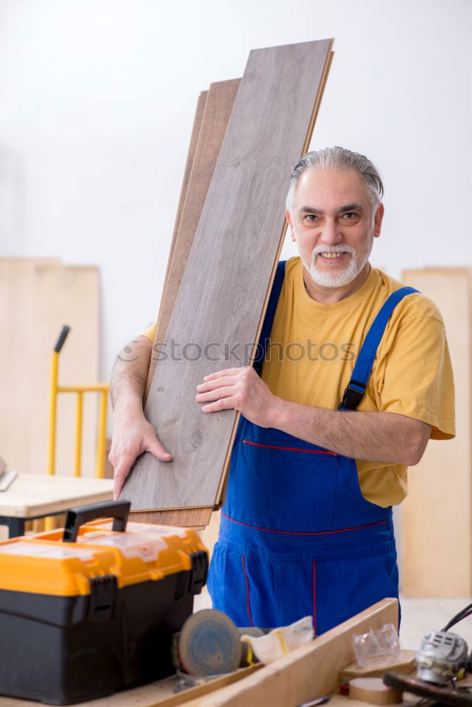 Similar – Carpenter cutting wooden board