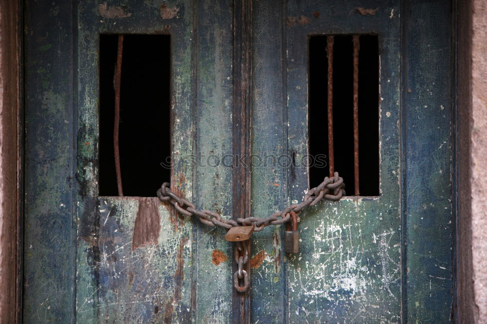 rusty garden gate closed with chain, with blurred background