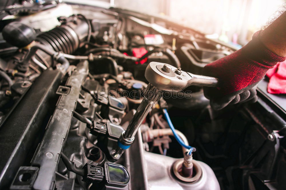 Similar – Professional Mechanic Repairing Car.