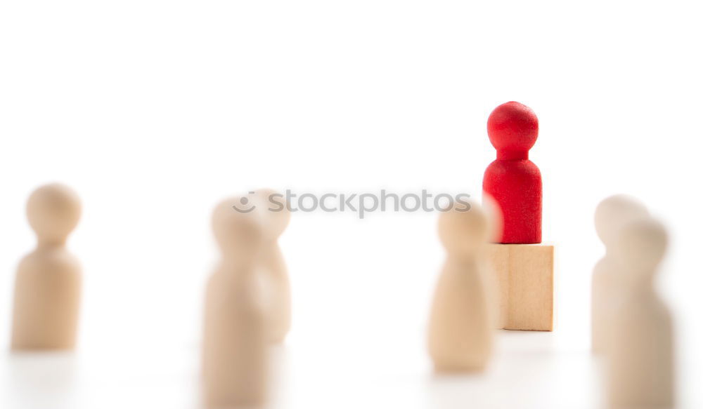 Similar – Single red toy figure in front of a row of black toy figures