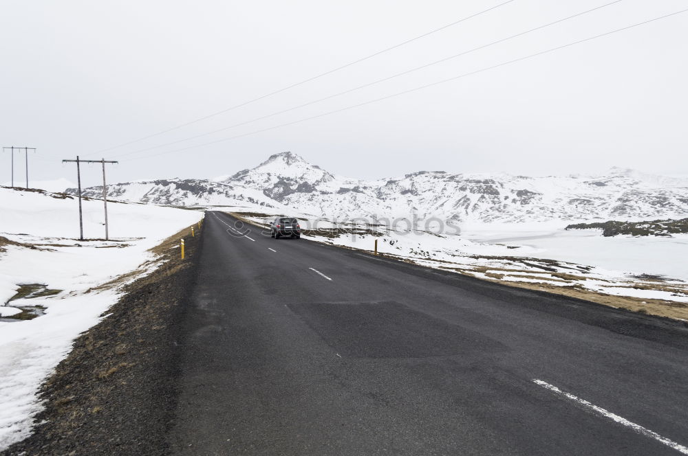 Similar – Image, Stock Photo Cyclist goes downhill along a mountain road in a snowy landscape