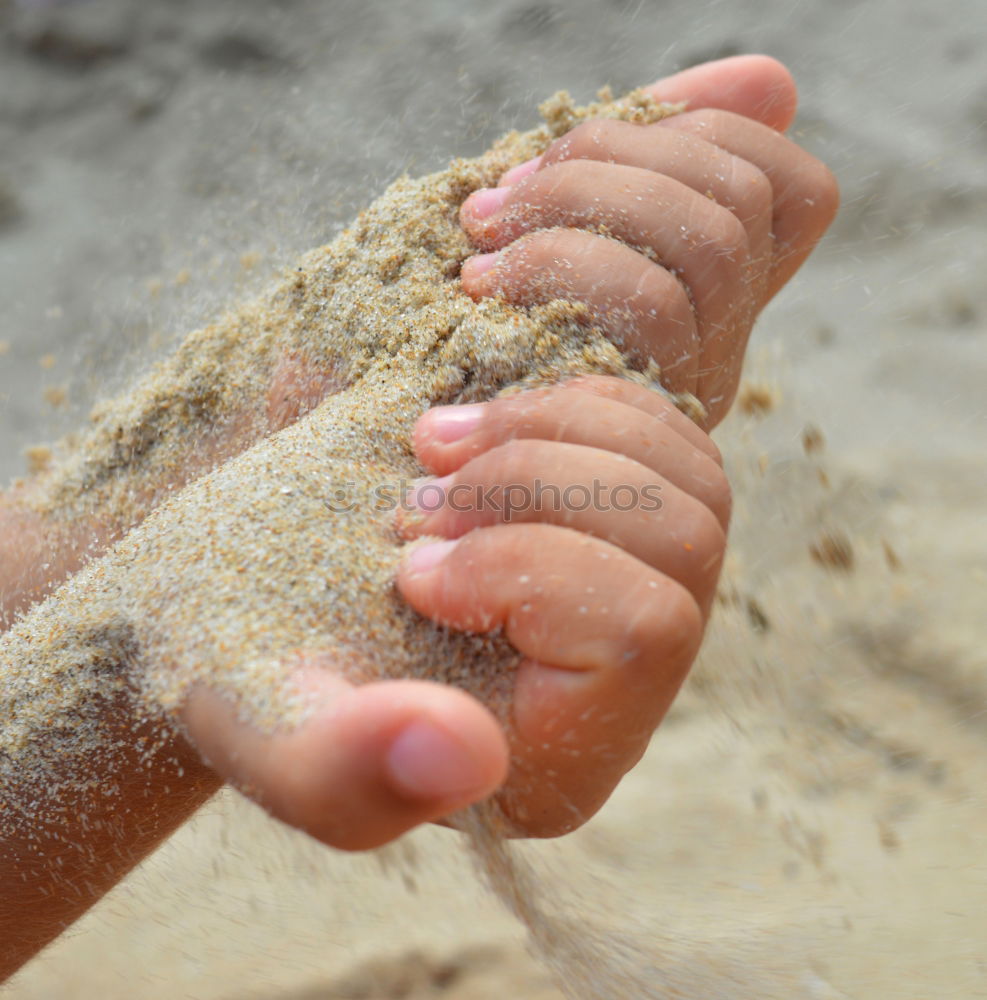 Similar – Child makes sand cake with bucket shape