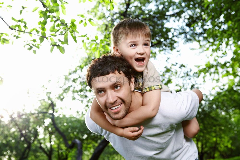 Image, Stock Photo Father and son playing at the park on bench at the day time.