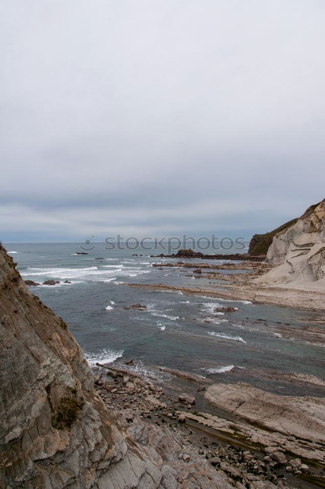 Similar – Woman sitting on cliff edge