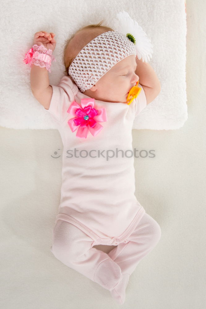 Similar – Baby girl in a bed with toys around.