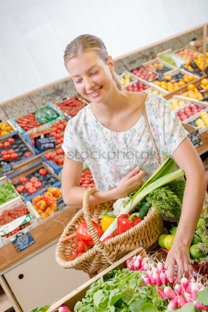 Similar – Image, Stock Photo Young woman shopping for fresh tomatoes at an open-air stall choosing items from a row of wooden boxes