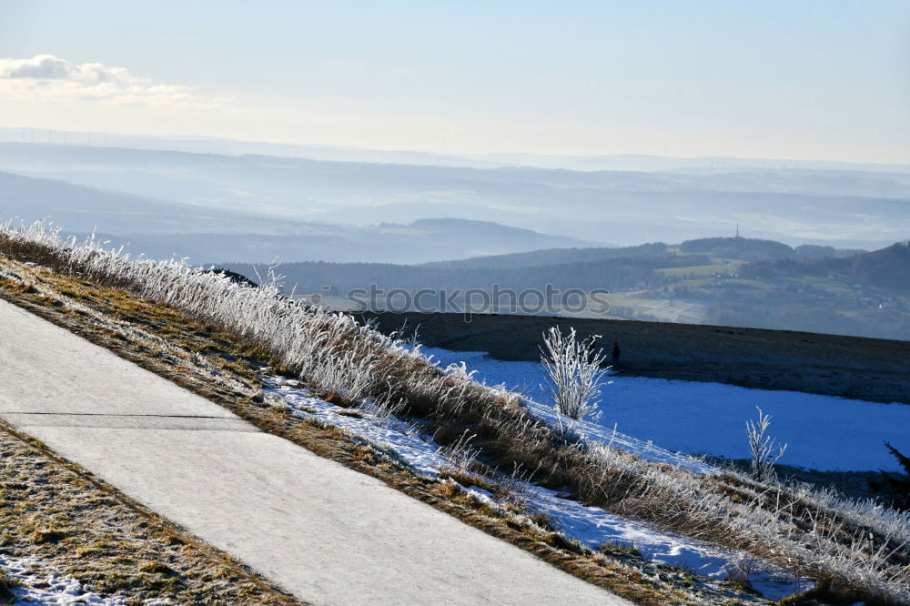 Similar – Image, Stock Photo Cyclist goes downhill along a mountain road in a snowy landscape