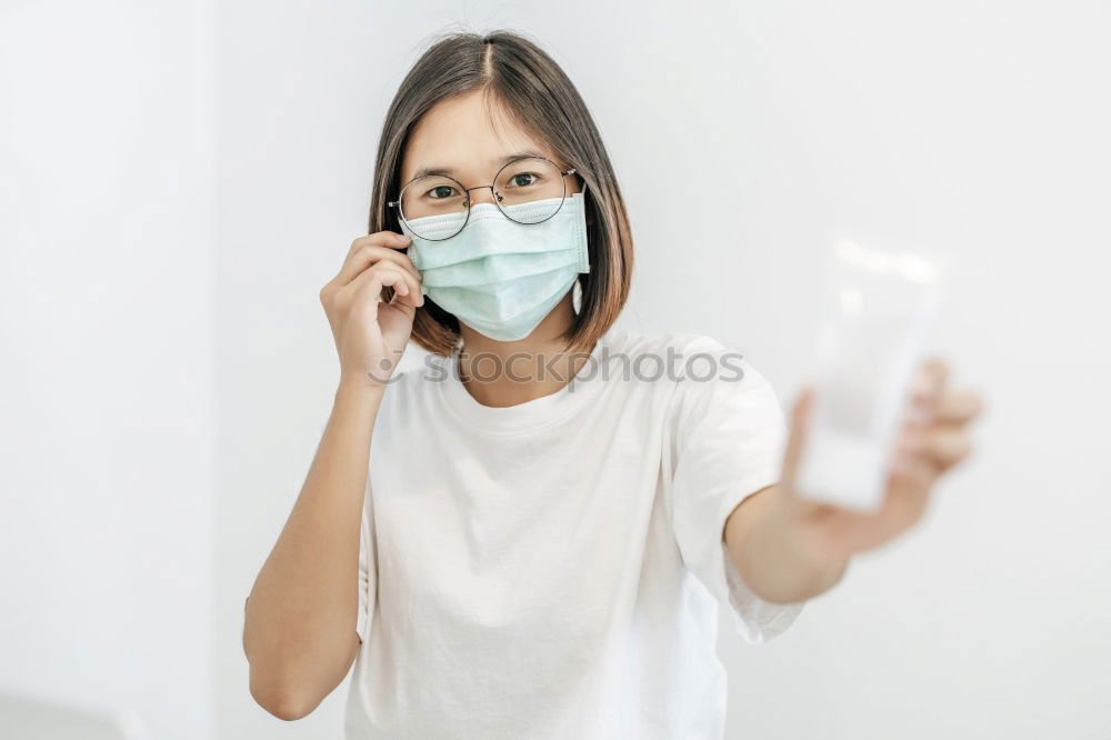 Similar – Image, Stock Photo Nurse with mouth guard examines laboratory sample