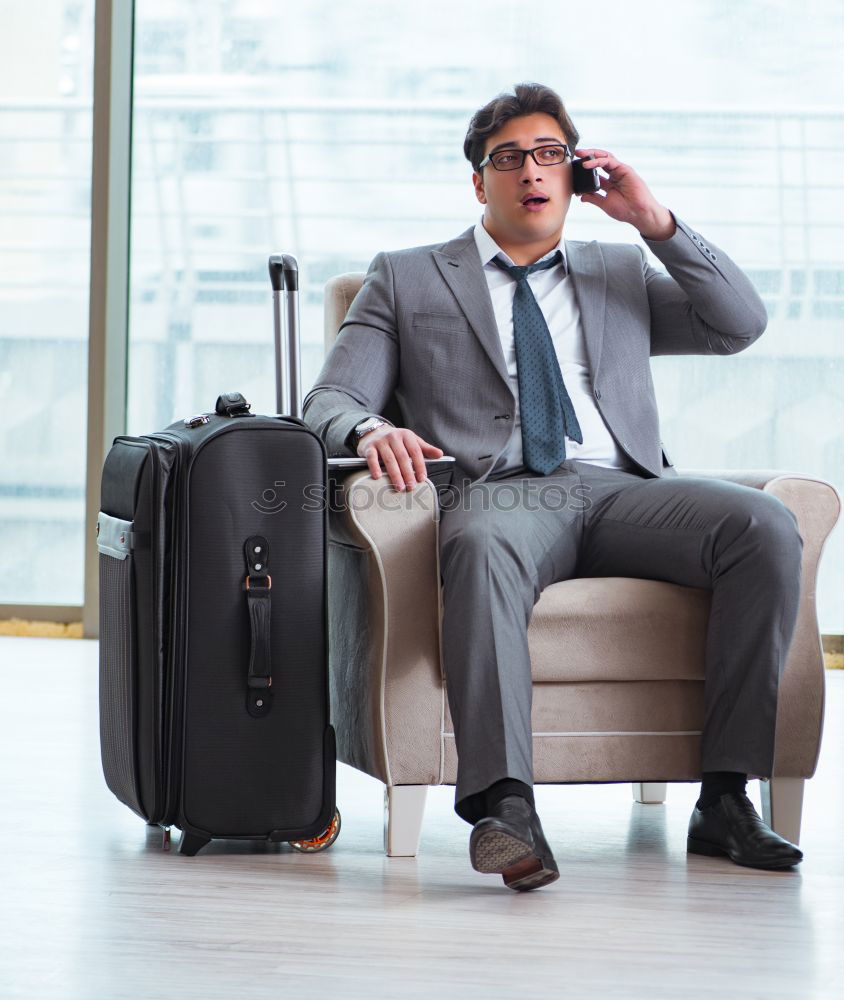 Image, Stock Photo Young business man standing with the suitcase at the airport waiting for the flight