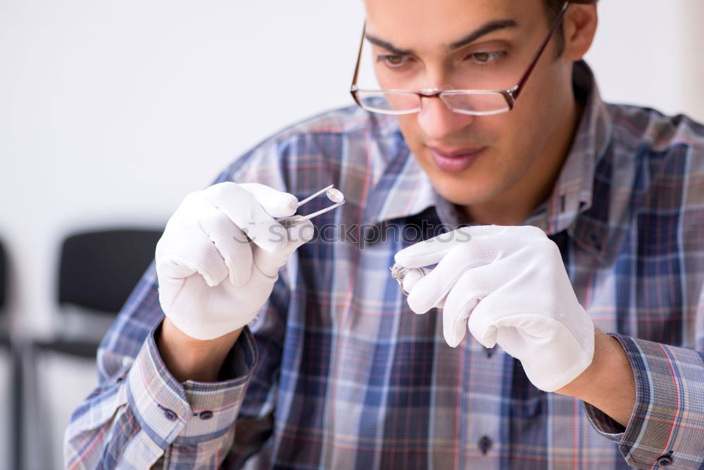 Similar – Man with a dust mask and goggles working on a circular saw