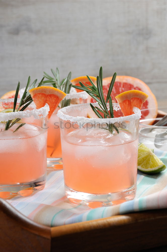 Similar – Two glasses of soft drink with honey- and watermelon, rosemary, ice cubes and drinking straw